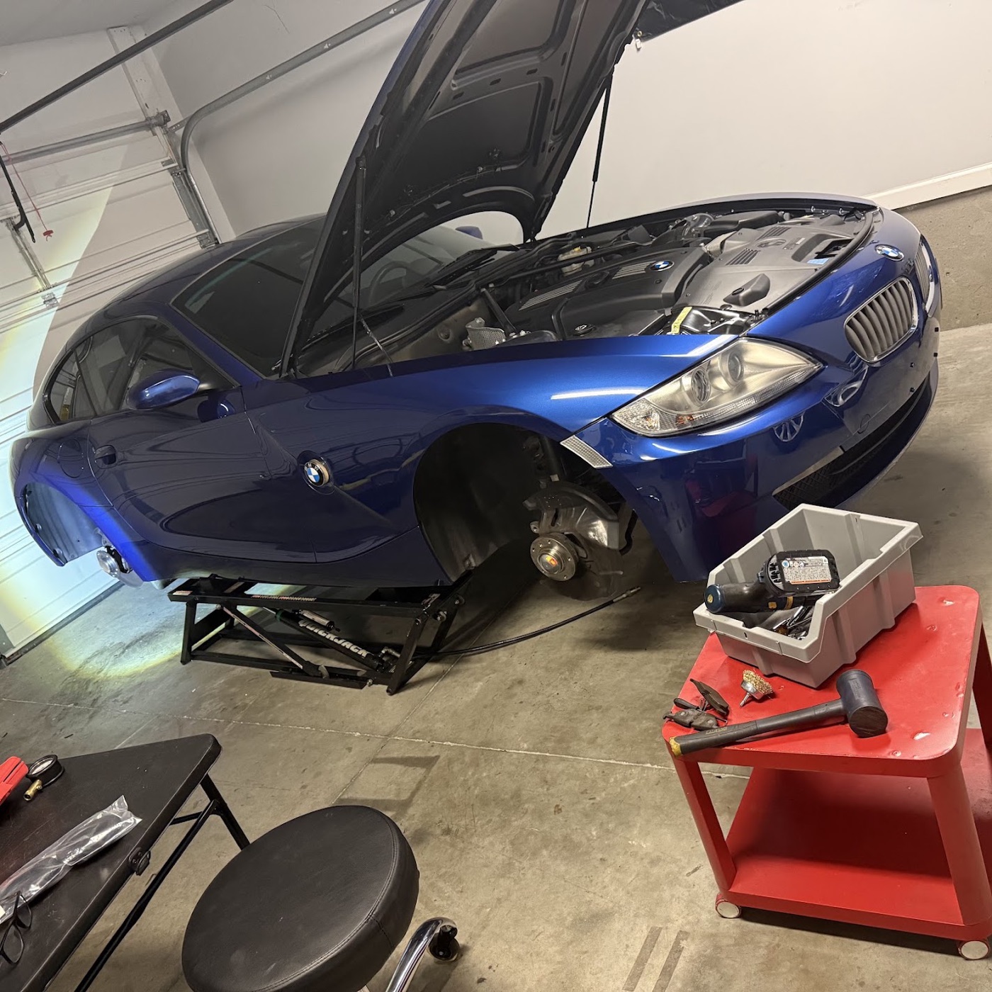 The E86 on the QuickJack, front wheel off, brakes apart