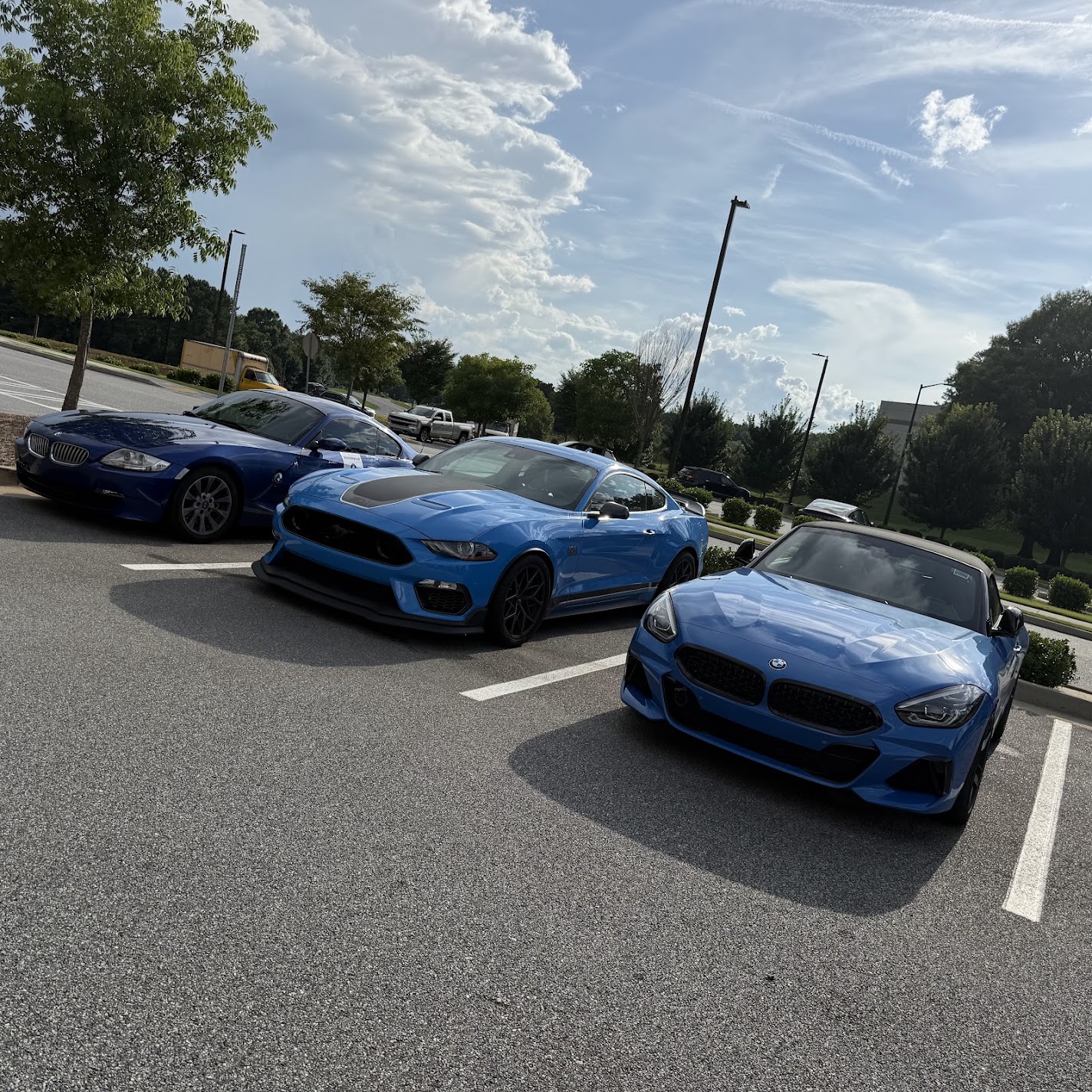 Three blue arguments in the paddock: the E86, Zach's Mach 1, and the M40i
